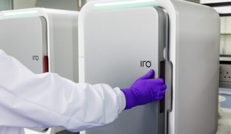 A person's gloved hand, opening the door of the IRO platform